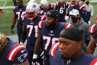 Isaiah Wynn of the New England Patriots walks off after warm ups